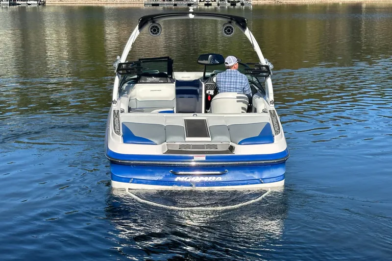 Slide: The Image of 2015 Moomba Mobius LSV boat cruising on a calm lake. - 62