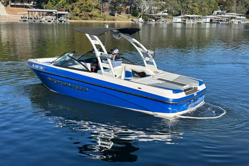 Slide: The Image of 2015 Moomba Mobius LSV boat cruising on a calm lake. - 64