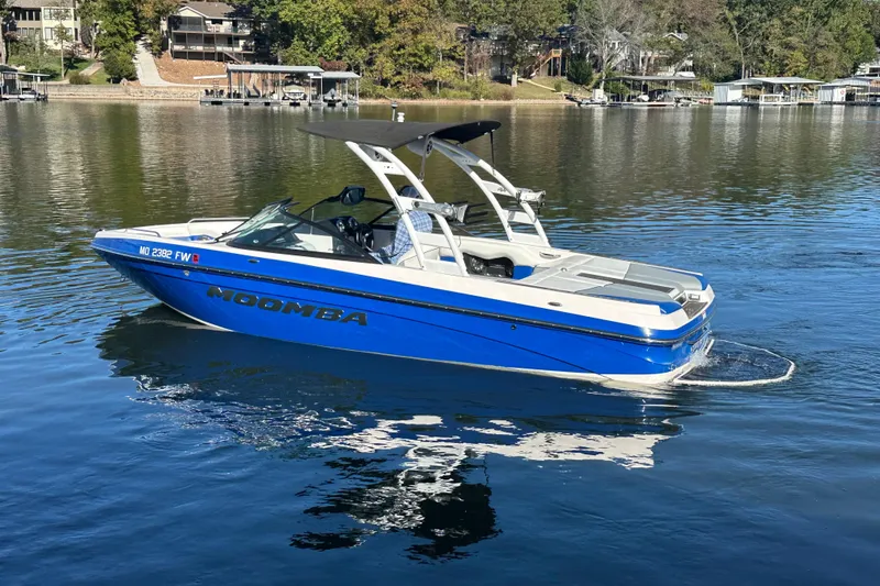Slide: The Image of 2015 Moomba Mobius LSV boat cruising on a serene lake. - 69