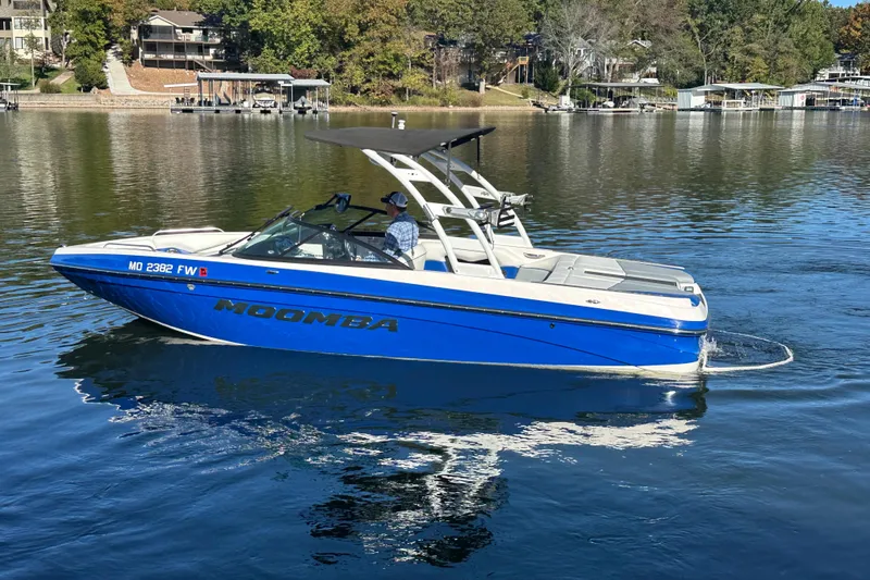 Slide: The Image of 2015 Moomba Mobius LSV boat cruising on a serene lake. - 71