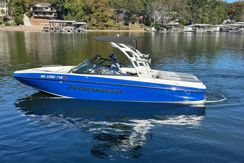 Slide: The Image of 2015 Moomba Mobius LSV boat on a calm lake with scenic background. - 72