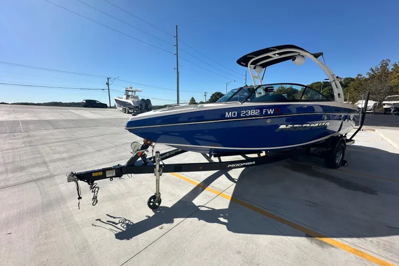 Slide: The Image of 2015 Moomba Mobius LSV boat interior with white and blue seating. - 9