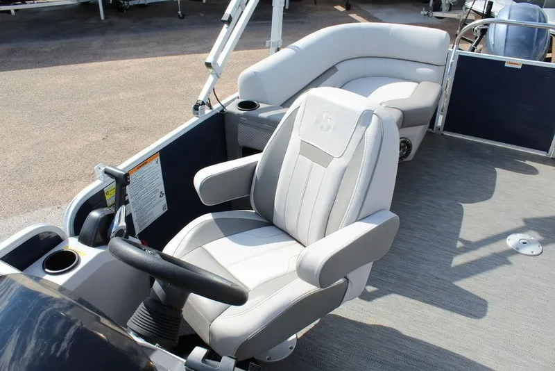 Slide: The Image of 2023 Godfrey Sweetwater 2286 C Sport Tube boat interior with captain's chair and seating area. - 10