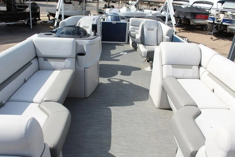 Slide: The Image of 2023 Godfrey Sweetwater 2286 C Sport Tube boat interior with spacious seating and helm. - 14