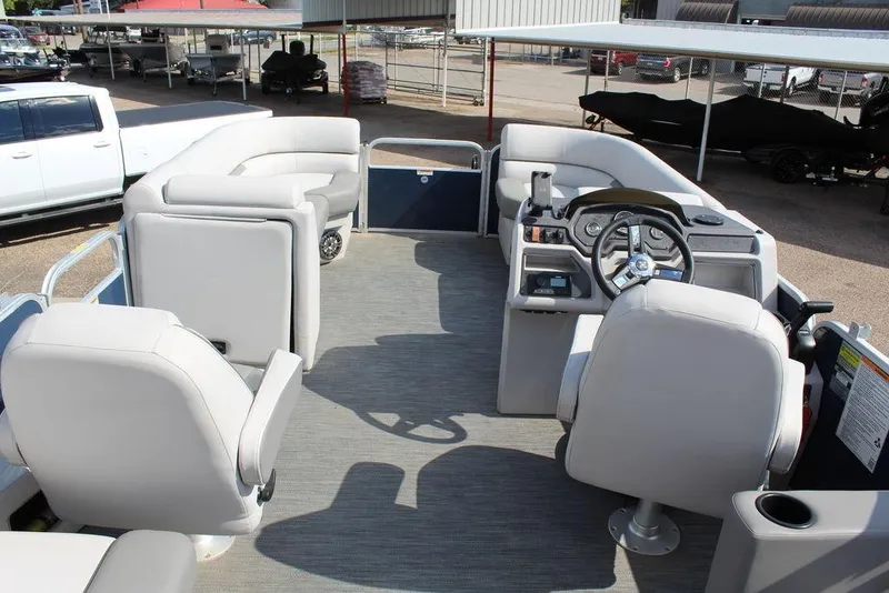 Slide: The Image of 2023 Godfrey Sweetwater 2286 C Sport Tube pontoon boat interior with seating and steering console. - 19