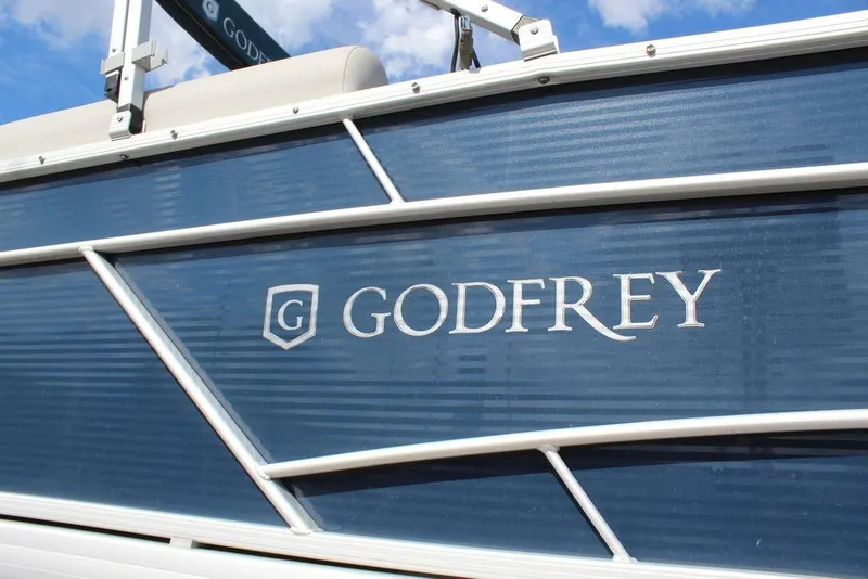 Slide: The Image of 2023 Godfrey Sweetwater 2286 C Sport Tube boat with blue paneling and logo. - 23