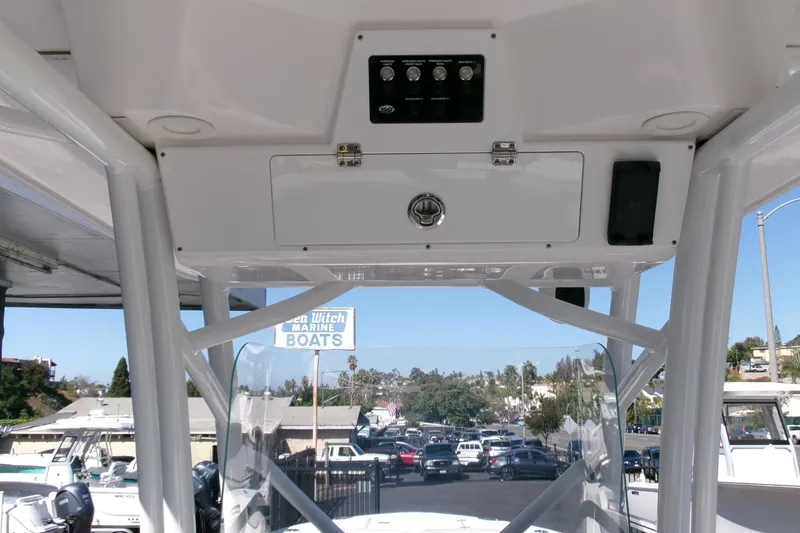 Slide: The Image of 2024 Sea Fox 248 Commander boat console with overhead storage and controls. - 18