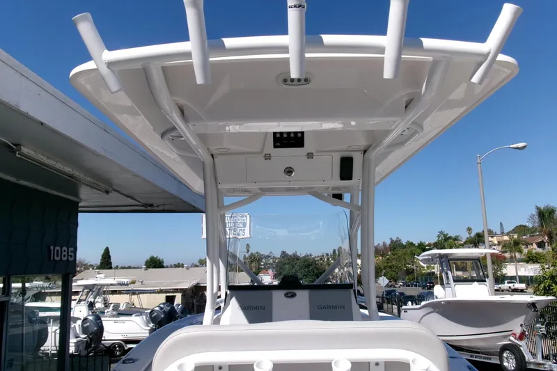 Slide: The Image of 2024 Sea Fox 248 Commander boat with T-top and Garmin electronics, docked outdoors. - 21