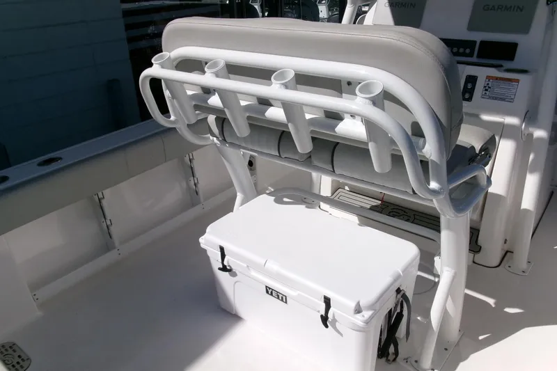 Slide: The Image of 2024 Sea Fox 248 Commander boat interior with rod holders and Yeti cooler. - 24