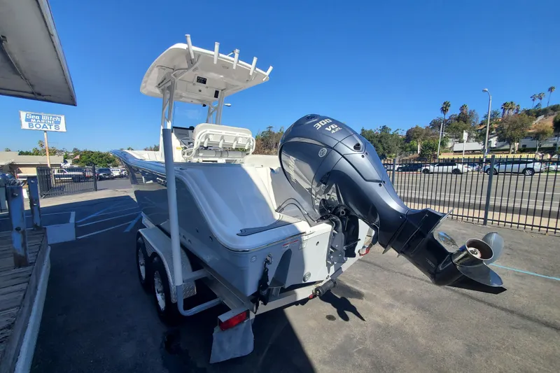 Slide: The Image of 2024 Sea Fox 248 Commander boat with powerful outboard motor in a marina setting. - 3