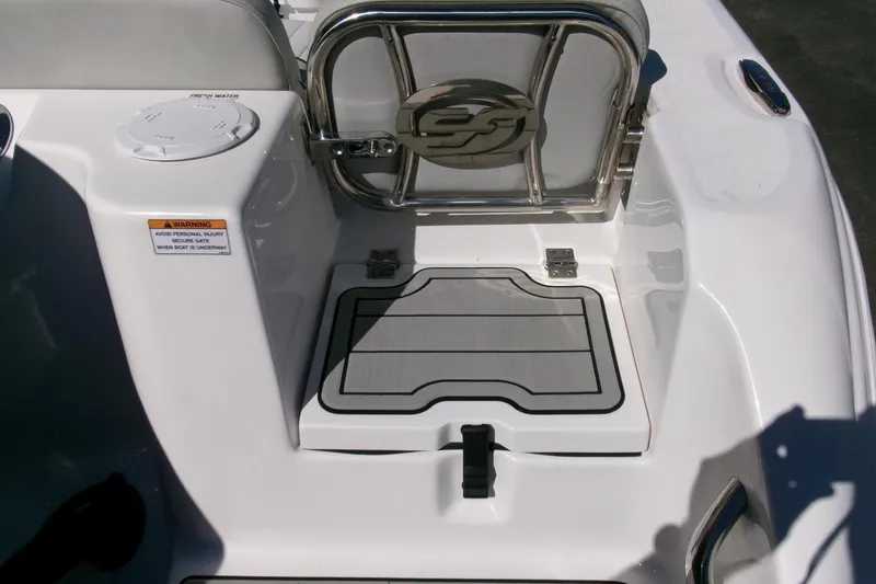 Slide: The Image of 2024 Sea Fox 248 Commander boat deck with safety gate and warning label. - 32