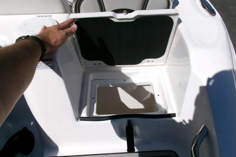 Slide: The Image of 2024 Sea Fox 248 Commander storage compartment with open lid, showcasing interior space. - 33