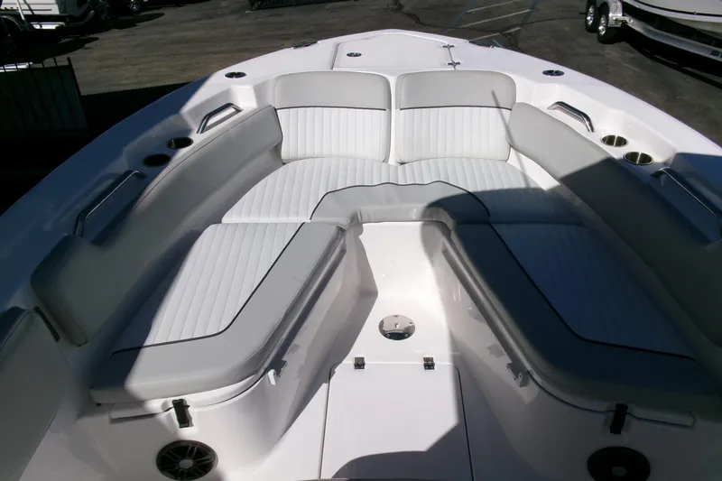 Slide: The Image of 2024 Sea Fox 248 Commander boat interior with white cushioned seating and cup holders. - 6