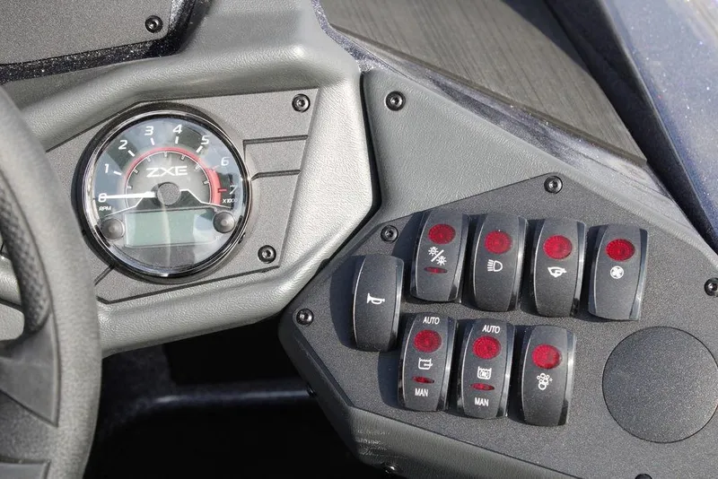 Slide: The Image of Control panel of 2026 Skeeter ZXE20 with RPM gauge and various switches. - 24