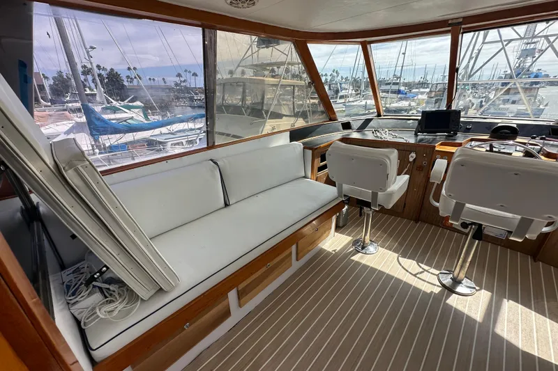 Slide: The Image of Interior of a 1973 Elliott Yachtfisher with white seating and navigation equipment. - 14