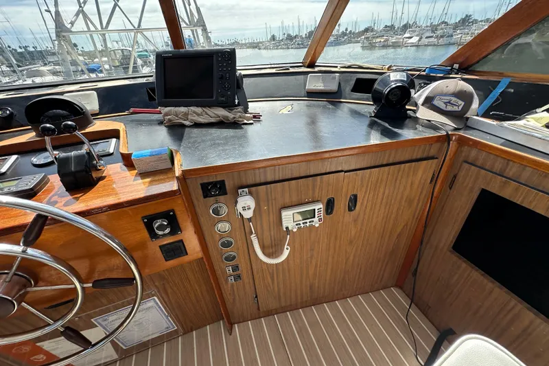 Slide: The Image of 1973 Elliott Yachtfisher interior with helm, white seating, and panoramic windows. - 19