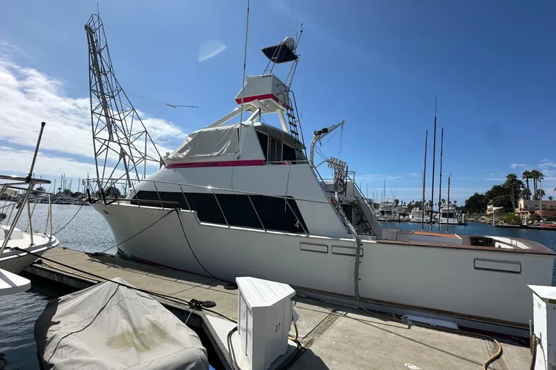 Slide: The Image of 1973 Elliott Yachtfisher docked in marina, surrounded by sailboats at sunset. - 2