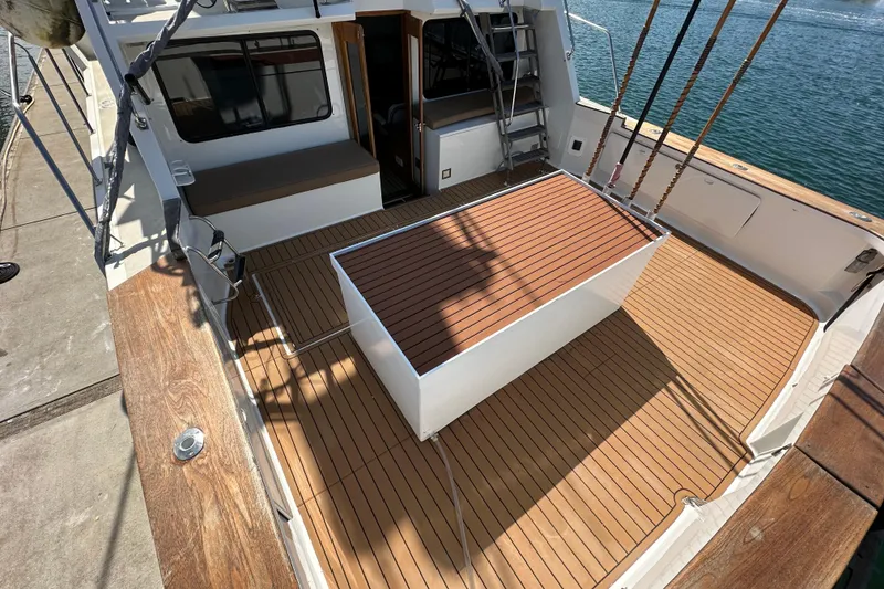 Slide: The Image of 1973 Elliott Yachtfisher helm with steering wheel, navigation equipment, and marina view. - 20