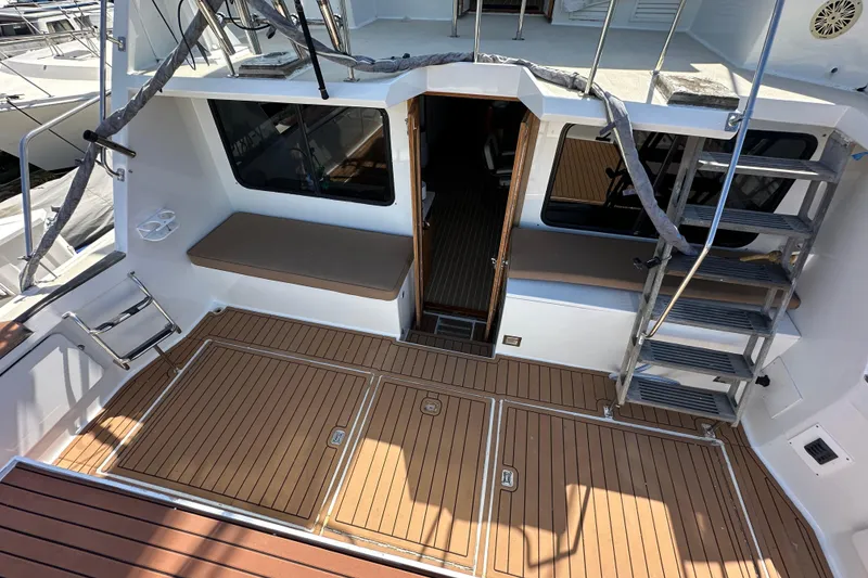 Slide: The Image of 1973 Elliott Yachtfisher with wooden deck, docked at marina, surrounded by other boats. - 25