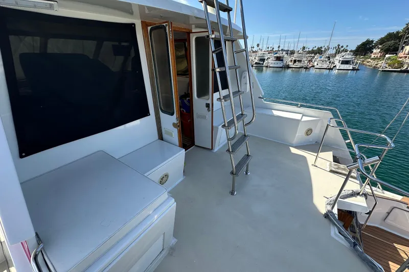 Slide: The Image of 1973 Elliott Yachtfisher docked at marina under clear blue sky. - 3