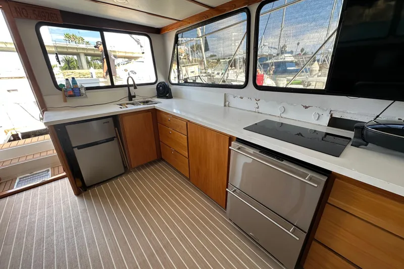 Slide: The Image of 1973 Elliott Yachtfisher bathroom with sink, mirror, and window view of marina. - 32