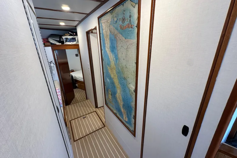 Slide: The Image of Interior hallway of a 1973 Elliott Yachtfisher, featuring wood trim and striped flooring. - 35