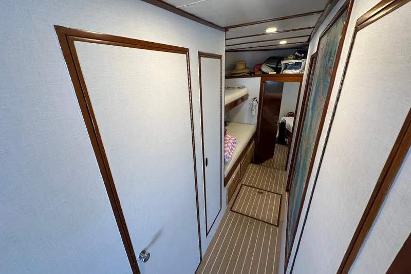 Slide: The Image of 1973 Elliott Yachtfisher interior with kitchen, dining area, and seating, featuring wood accents and nautical decor. - 36
