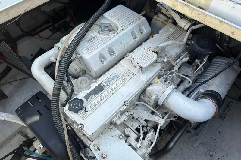 Slide: The Image of 1973 Elliott Yachtfisher interior with bunk beds, nautical pillows, and wooden flooring. - 40