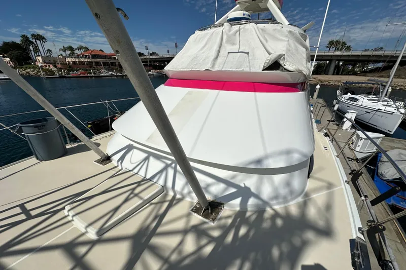 Slide: The Image of 1973 Elliott Yachtfisher deck with ladder, marina view, and clear blue sky. - 5