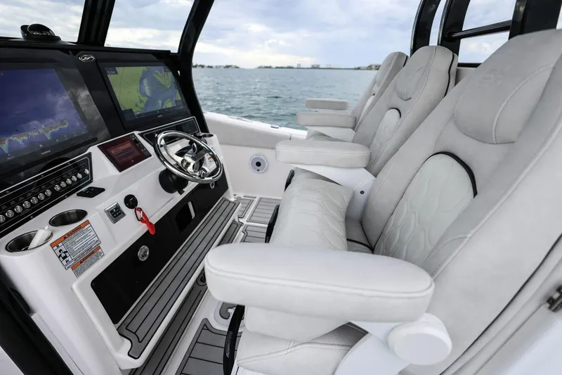 Slide: The Image of 2022 Sea Fox 368 Commander helm with advanced navigation displays and luxurious seating. - 18