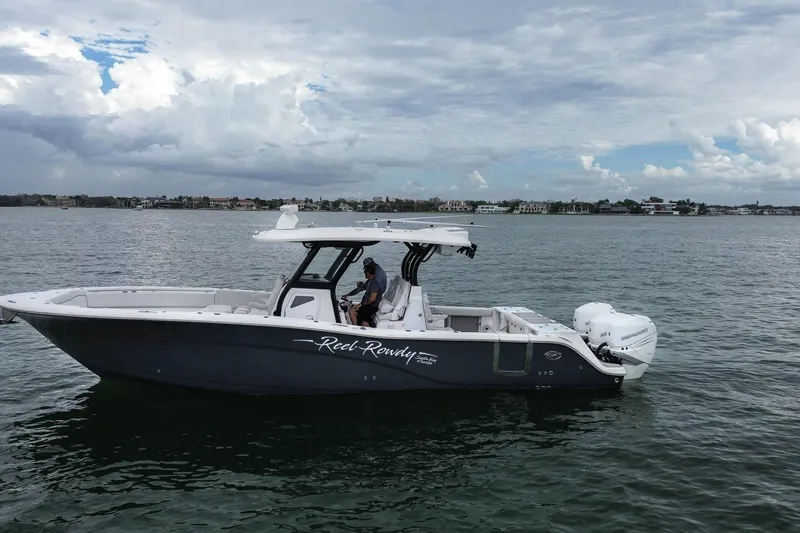 Slide: The Image of 2022 Sea Fox 368 Commander boat on calm water under cloudy sky. - 2