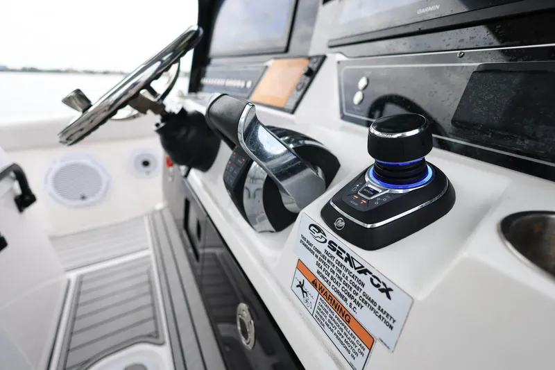 Slide: The Image of 2022 Sea Fox 368 Commander helm with advanced controls and steering wheel. - 21