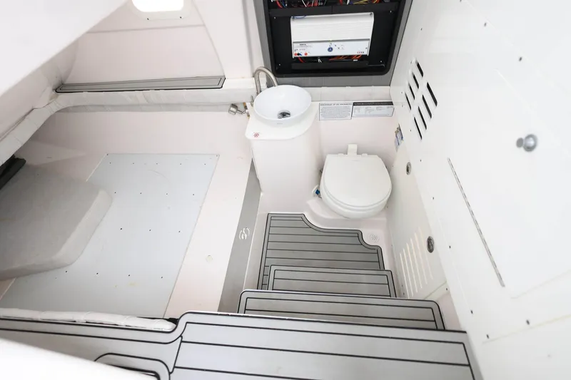 Slide: The Image of Interior of 2022 Sea Fox 368 Commander boat featuring a compact bathroom area. - 23