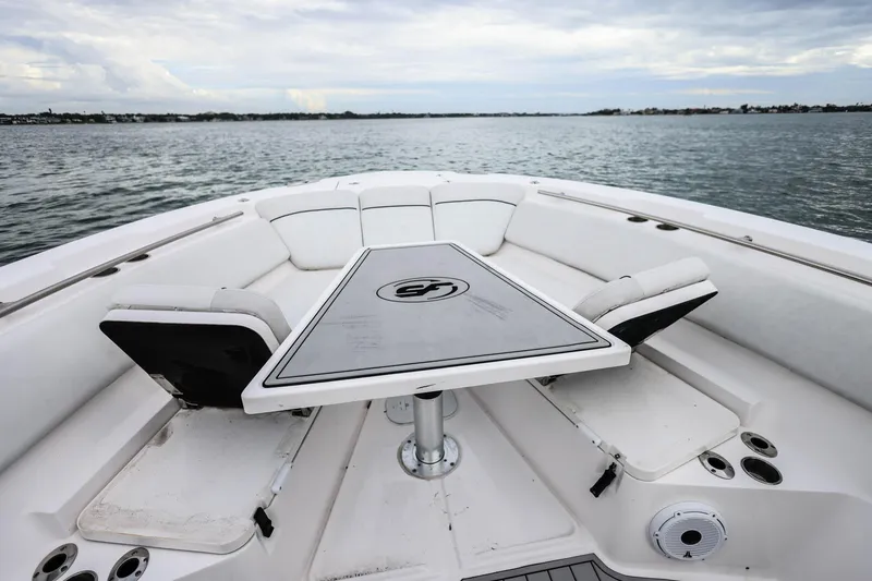 Slide: The Image of 2022 Sea Fox 368 Commander boat interior with seating and table on open water. - 32