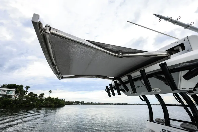 Slide: The Image of 2022 Sea Fox 368 Commander boat with extended canopy on a calm waterway. - 35