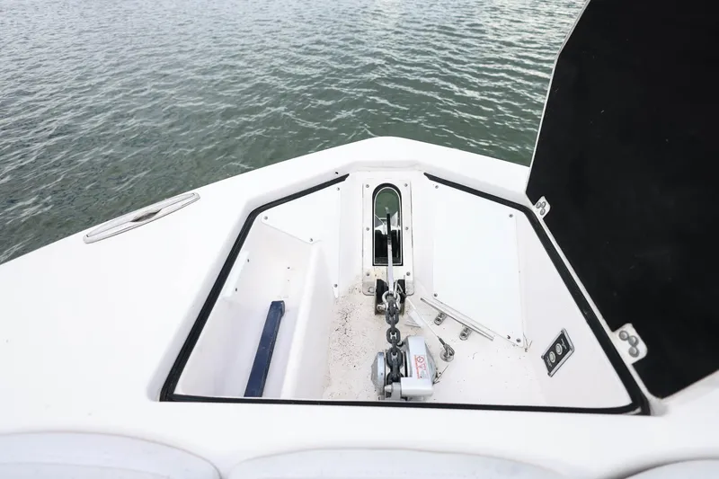 Slide: The Image of 2022 Sea Fox 368 Commander anchor compartment with chain and winch, on calm water. - 41