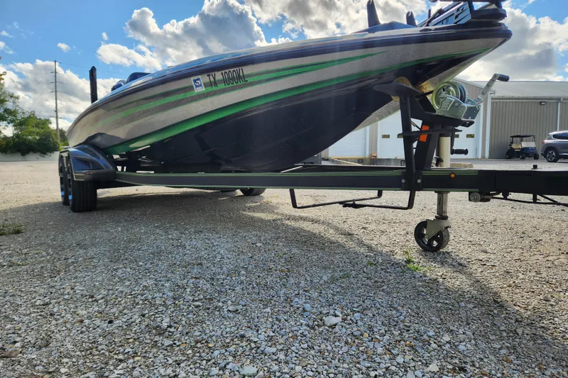 Slide: The Image of 2019 Skeeter FX21 boat on trailer under a cloudy sky. - 10