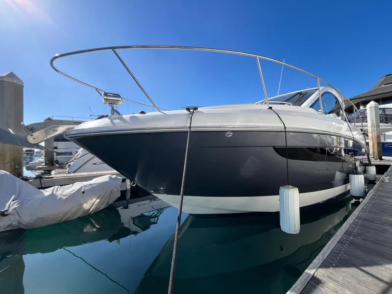 Slide: The Image of 2018 Sea Ray Sundancer 350 yacht docked at marina under clear blue sky. - 13