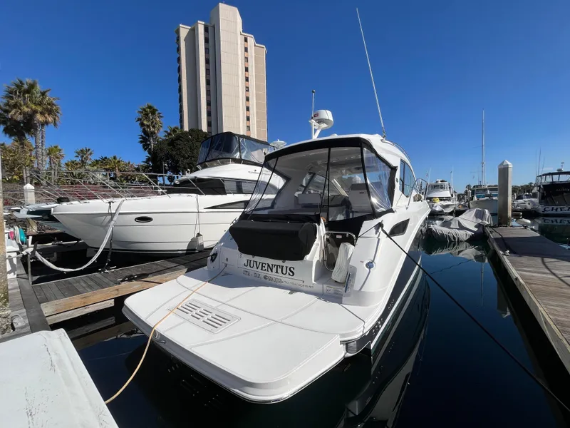 Slide: The Image of 2018 Sea Ray Sundancer 350 docked at marina with clear blue sky. - 2