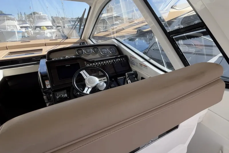 Slide: The Image of 2018 Sea Ray Sundancer 350 helm with modern controls and sleek design. - 22