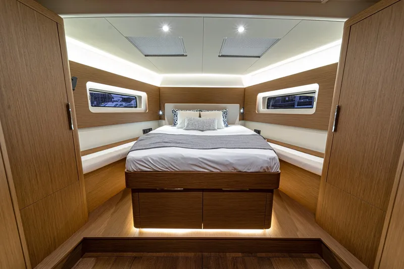 Slide: The Image of Luxurious cabin interior of 2026 Beneteau Oceanis Yacht 54 with modern wood finish. - 10