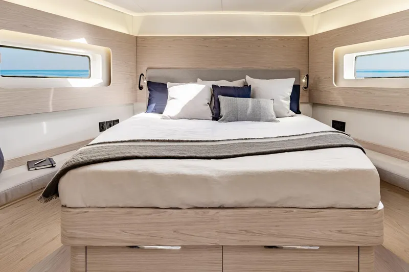 Slide: The Image of Luxurious bedroom interior of 2026 Beneteau Oceanis Yacht 54 with modern design and ocean view. - 11