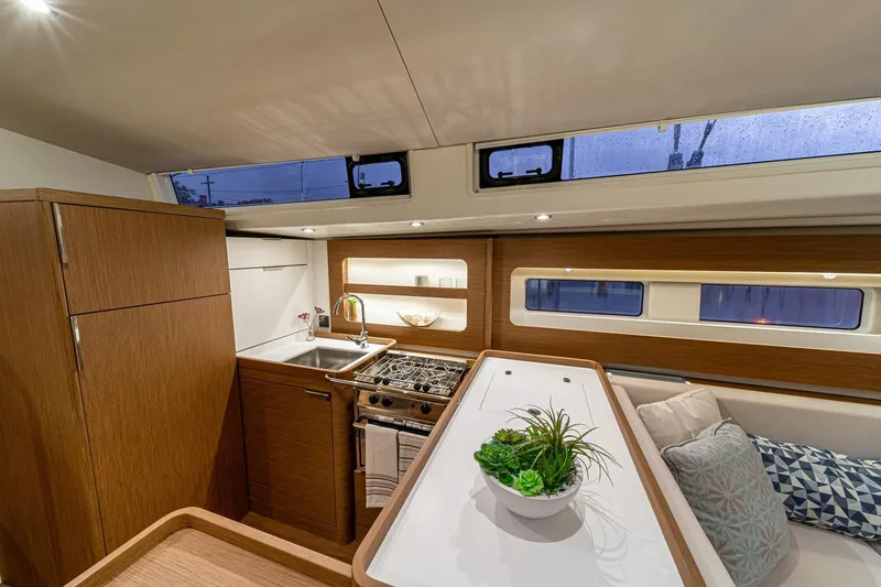 Slide: The Image of Luxurious interior of 2026 Beneteau Oceanis Yacht 54 with modern kitchen and seating area. - 14