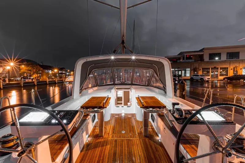 Slide: The Image of Luxurious 2026 Beneteau Oceanis Yacht 54 docked at night, showcasing elegant deck design. - 3