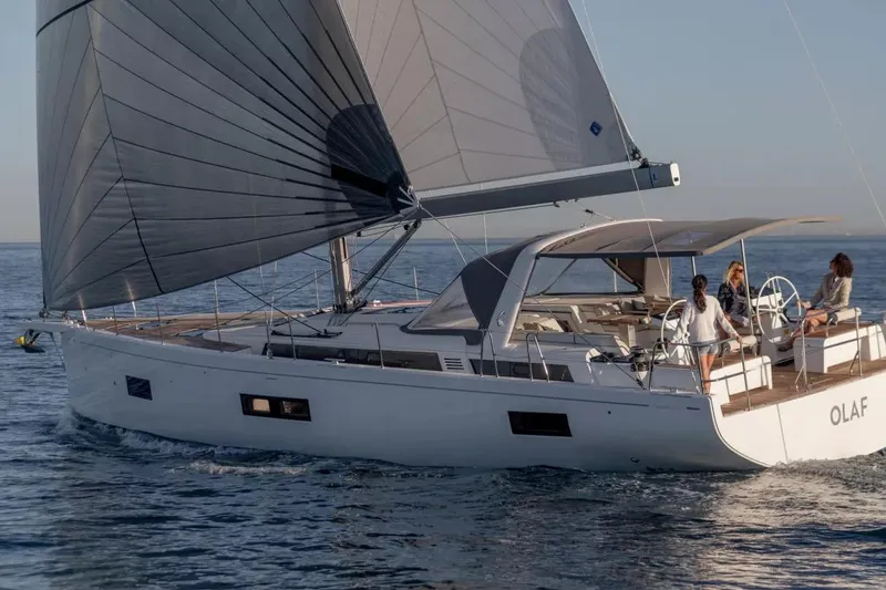 Slide: The Image of 2026 Beneteau Oceanis Yacht 54 sailing on open water with passengers on deck. - 4