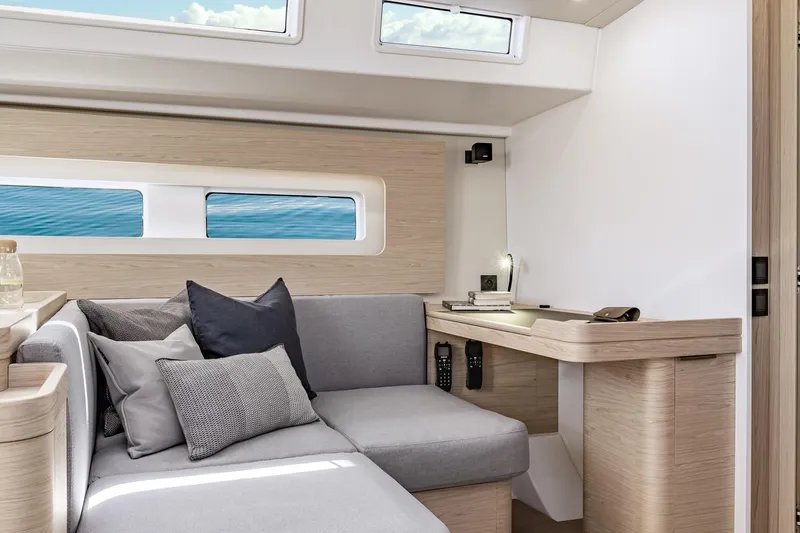 Slide: The Image of Luxurious interior of 2026 Beneteau Oceanis Yacht 54 with modern seating and desk area. - 8