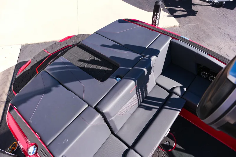 Slide: The Image of 2026 MasterCraft NXT22 boat interior with sleek gray seating and red accents. - 11
