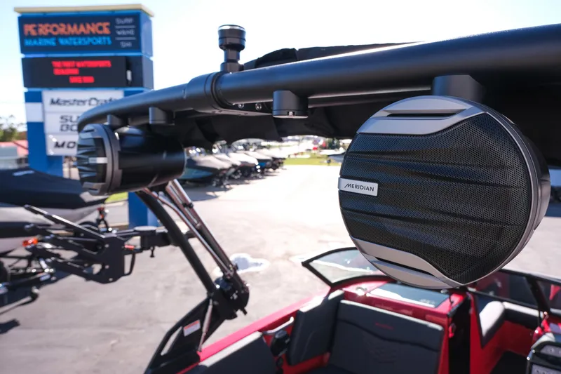 Slide: The Image of 2026 MasterCraft NXT22 boat with Meridian speakers at a marine dealership. - 12