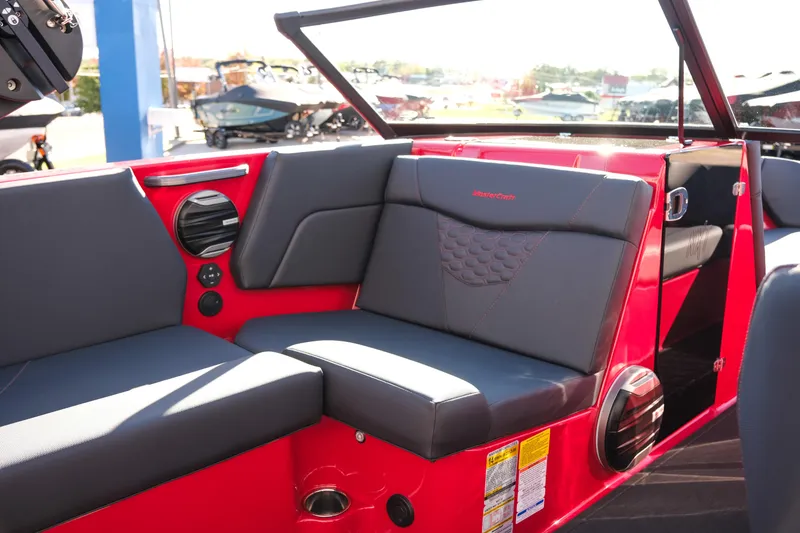 Slide: The Image of 2026 MasterCraft NXT22 boat interior with red and gray seating, featuring modern design elements. - 14