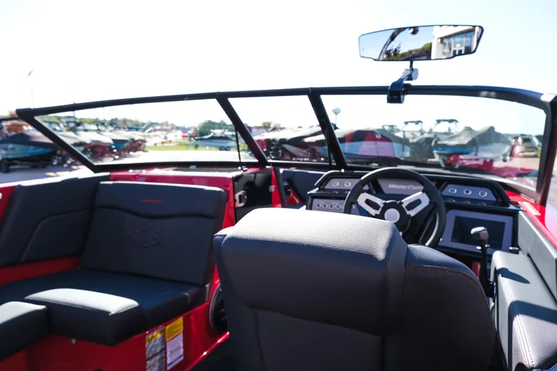 Slide: The Image of 2026 MasterCraft NXT22 boat interior with steering wheel and seating. - 15